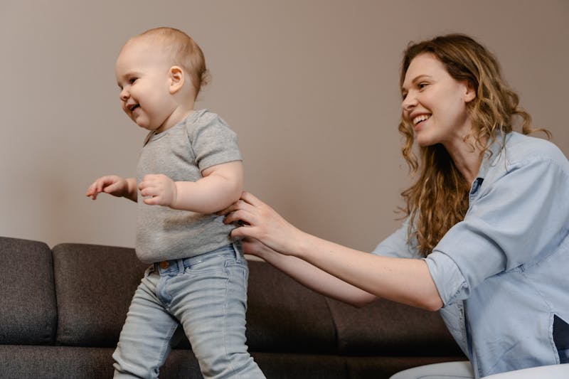 A toddler taking first steps